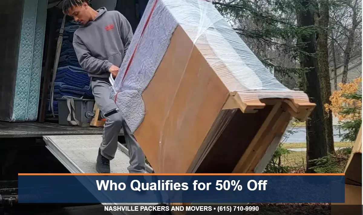 Mover rolling wrapped furniture on a dolly - moving assistance for low income families